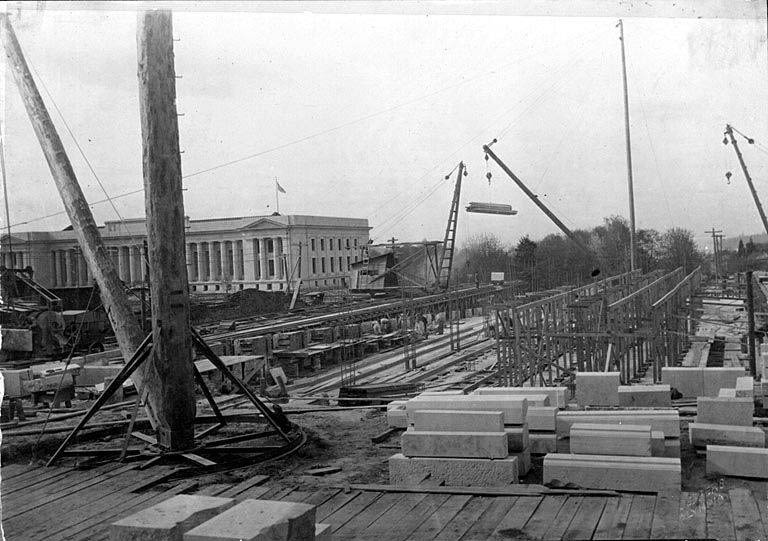 #4 Construction begins on Insurance Building with Temple of Justice in background, Washington State Capitol complex, Olympia, April 30, 1920