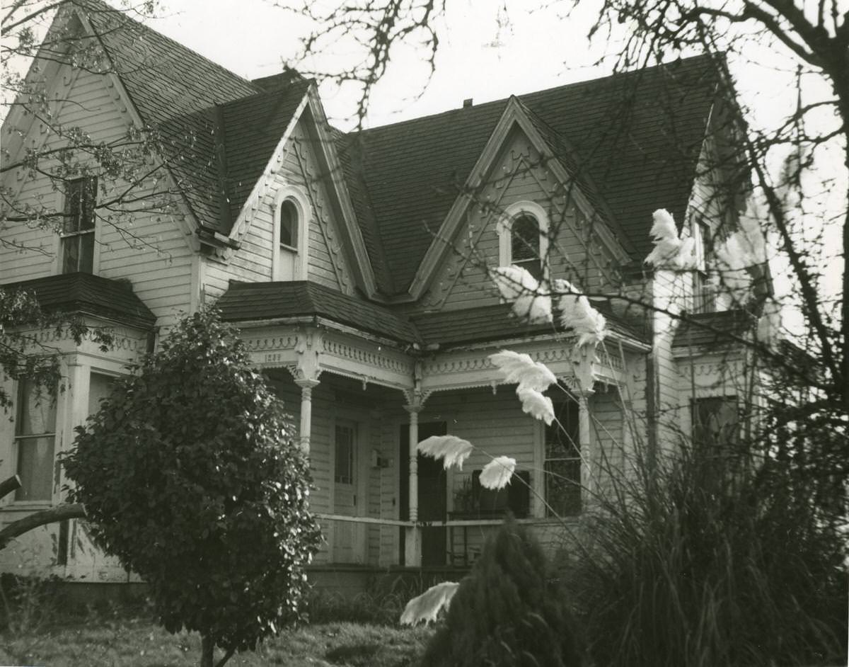 #26 Two-story wooden house with arched windows and porch at 8th Avenue East, Olympia, 1968