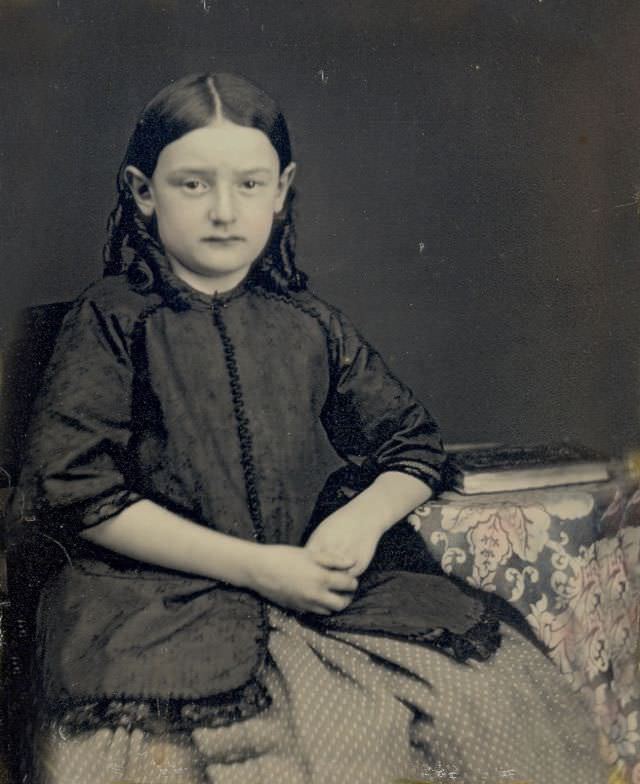 #16 A young school girl posed with her book