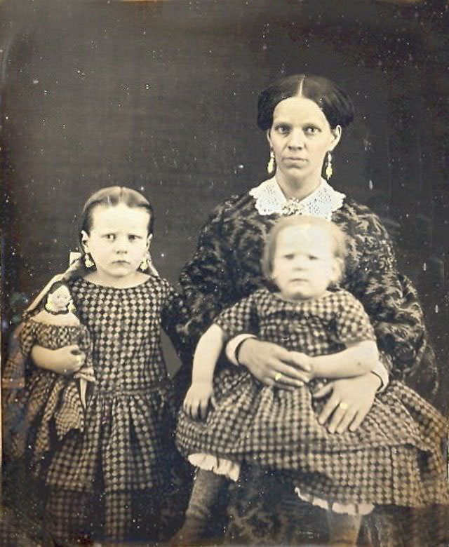#27 Mom and her two girls in matching dresses including the doll