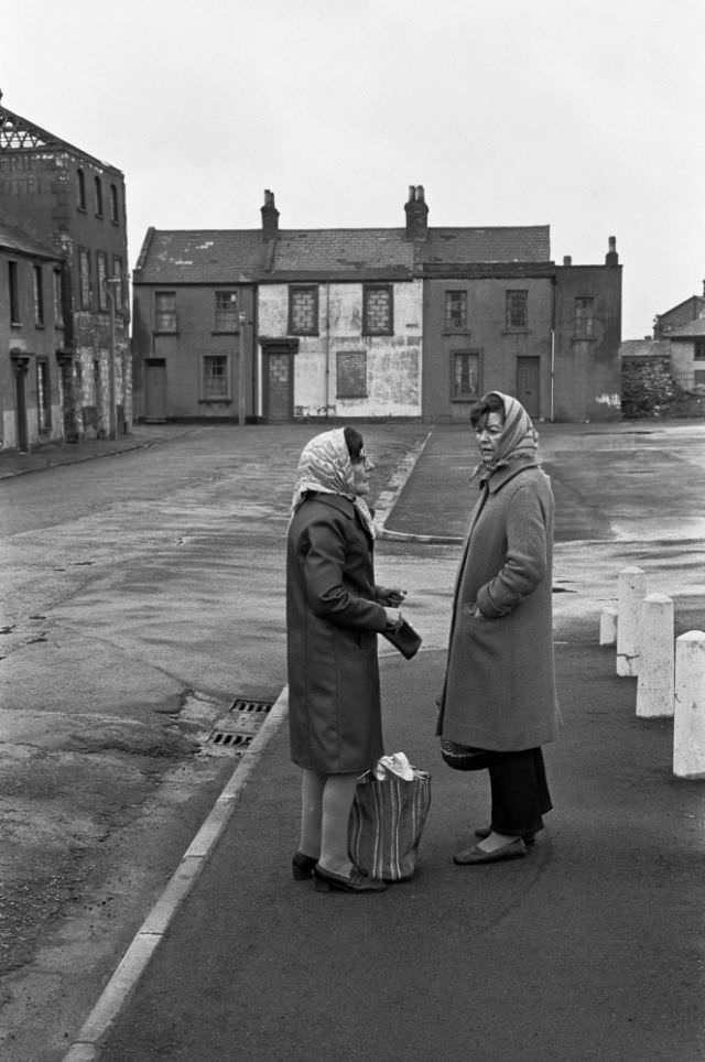 #21 Women chatting in a street of boarded up houses awaiting demolition, Butetown (Tiger Bay), Cardiff