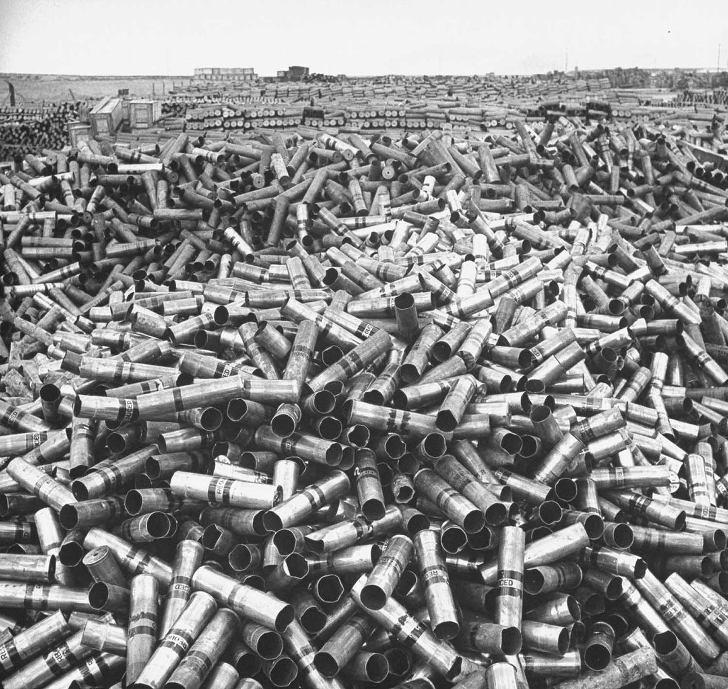 #3 18 million pounds of scrap brass is piled up at a U.S. Army depot storing unused equipment, 1946.
