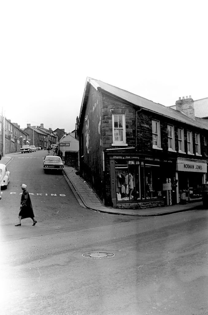 #44 A woman crosses the street in the mining town of Tonypandy, Wales, United Kingdom, 1966.