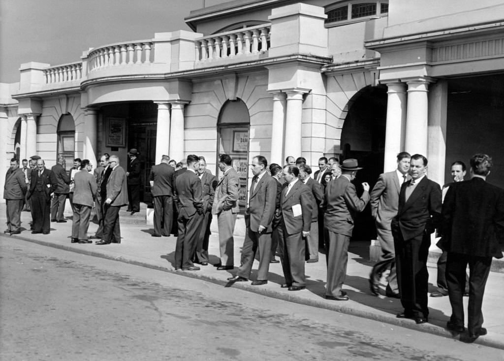 #67 Miners wait outside of the Pavilion at Porthcawl, for the annual NUM South Wales miners conference, Porthcawl, Bridgend, South Wales, 1st May 1962.