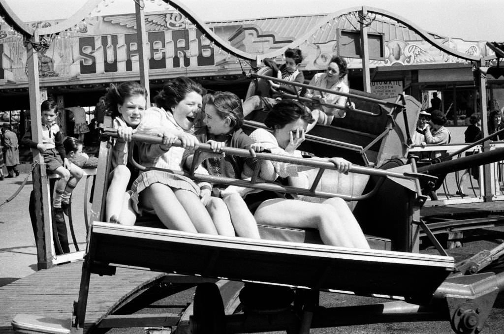 #68 A group of girls at the fairground at Barry Island, Vale of Glamorgan, Wales, 23rd April 1962.