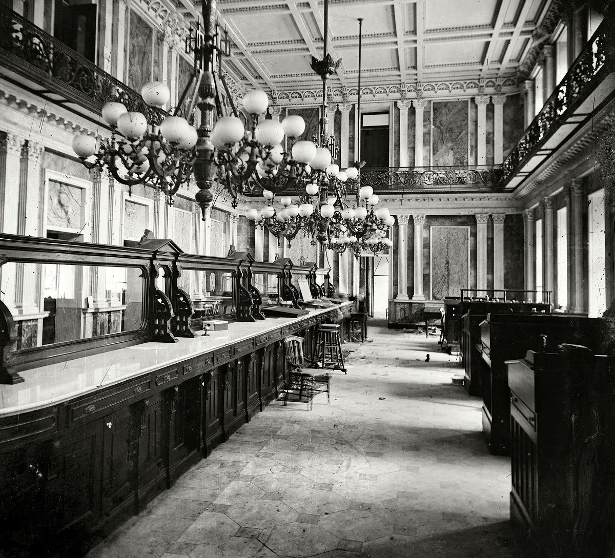 #11 Treasury Department in Lincoln’s time (Cash Room behind the desks).” At least two spectral presences here. Civil War glass negative collection, Washington, D.C., 1863.