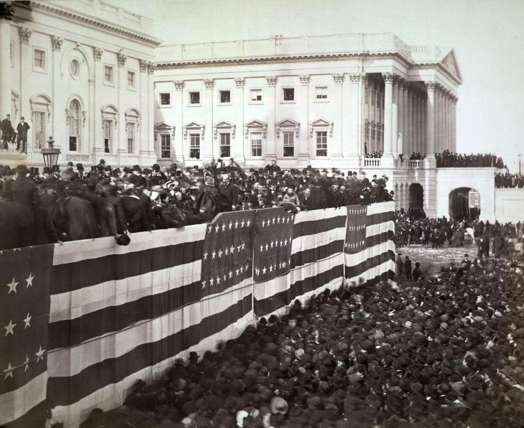 #73 Chief Justice Morrison R Waite administering the oath of office to James A Garfield on the east portico of the US Capitol, Washington DC, 1881
