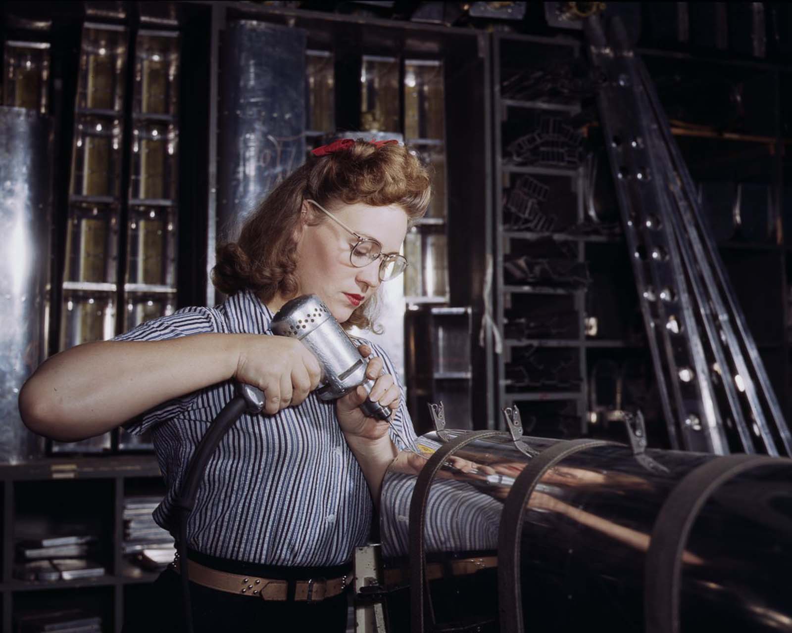 #13 A North American Aviation employee assembles a section of the leading edge for the horizontal stabilizer of a plane at the plant in Inglewood, California, 1942.