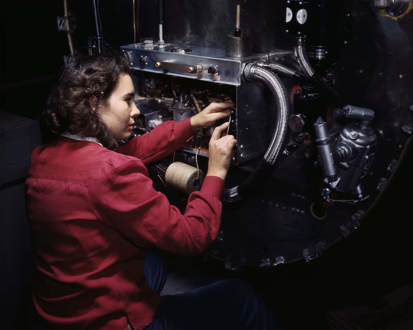 #14 A worker assembles switch boxes on the firewall of a B-25 bomber at the North American Aviation plant in Inglewood, California, 1942.