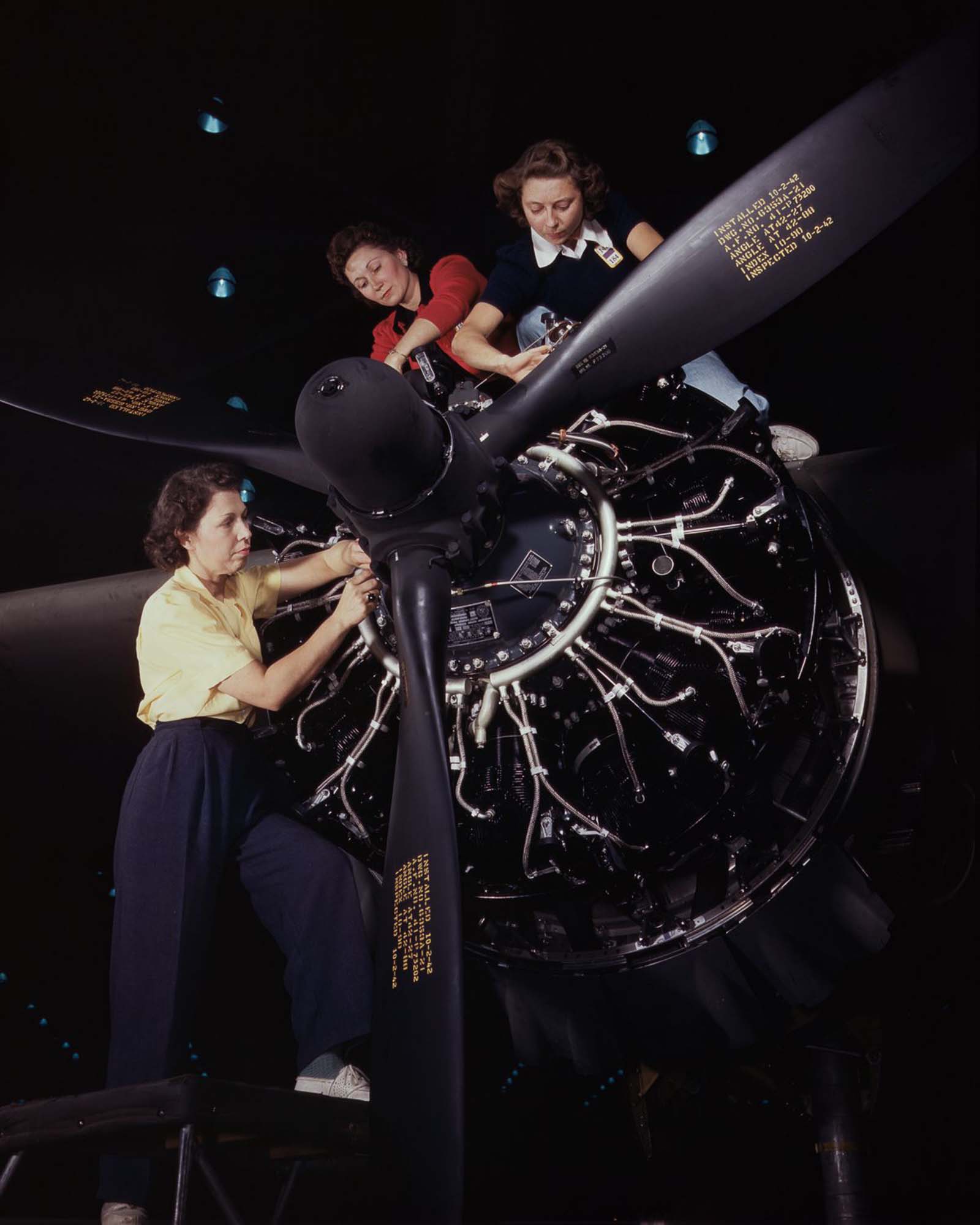 #3 Workers assemble an airplane motor at the Douglas Aircraft Company plant in Long Beach, California, 1942.