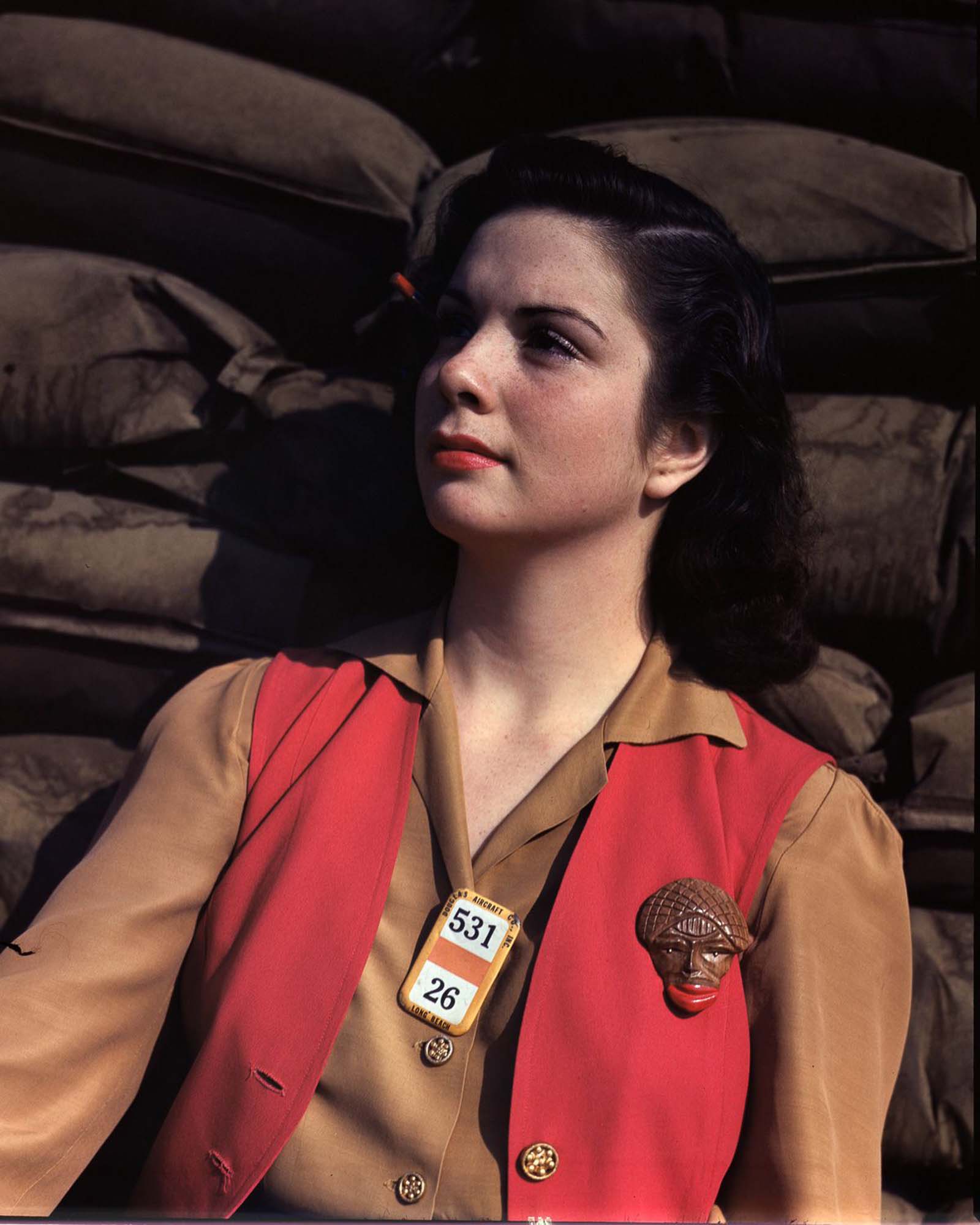 #22 A Douglas Aircraft Company employee on her lunch break at the plant in Long Beach, California, 1942.