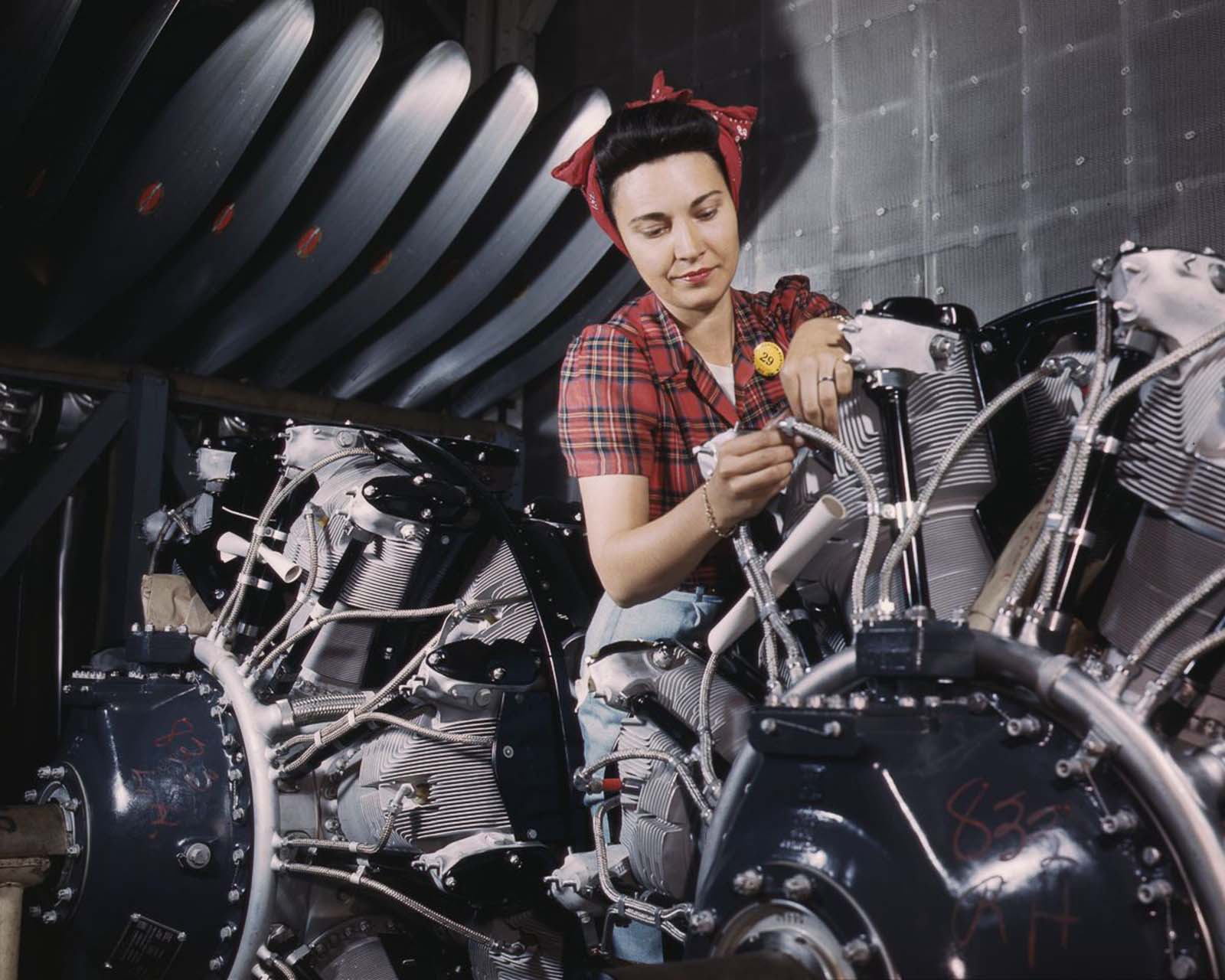 #26 A worker adjusts an airplane motor at the North American Aviation plant in Inglewood, California, 1942.