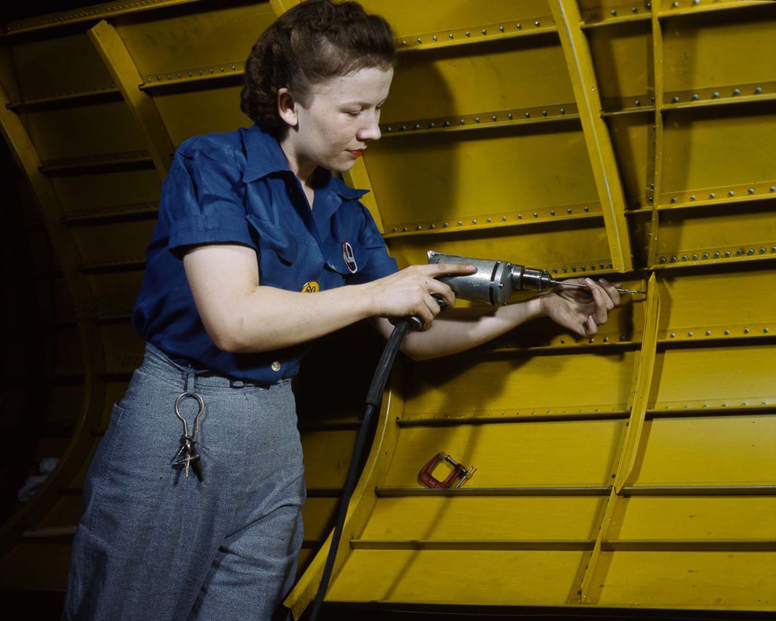 #27 A worker uses a power drill on an A-31 “Vengeance” dive bomber at the Vultee factory in Nashville, Tennessee, 1943.