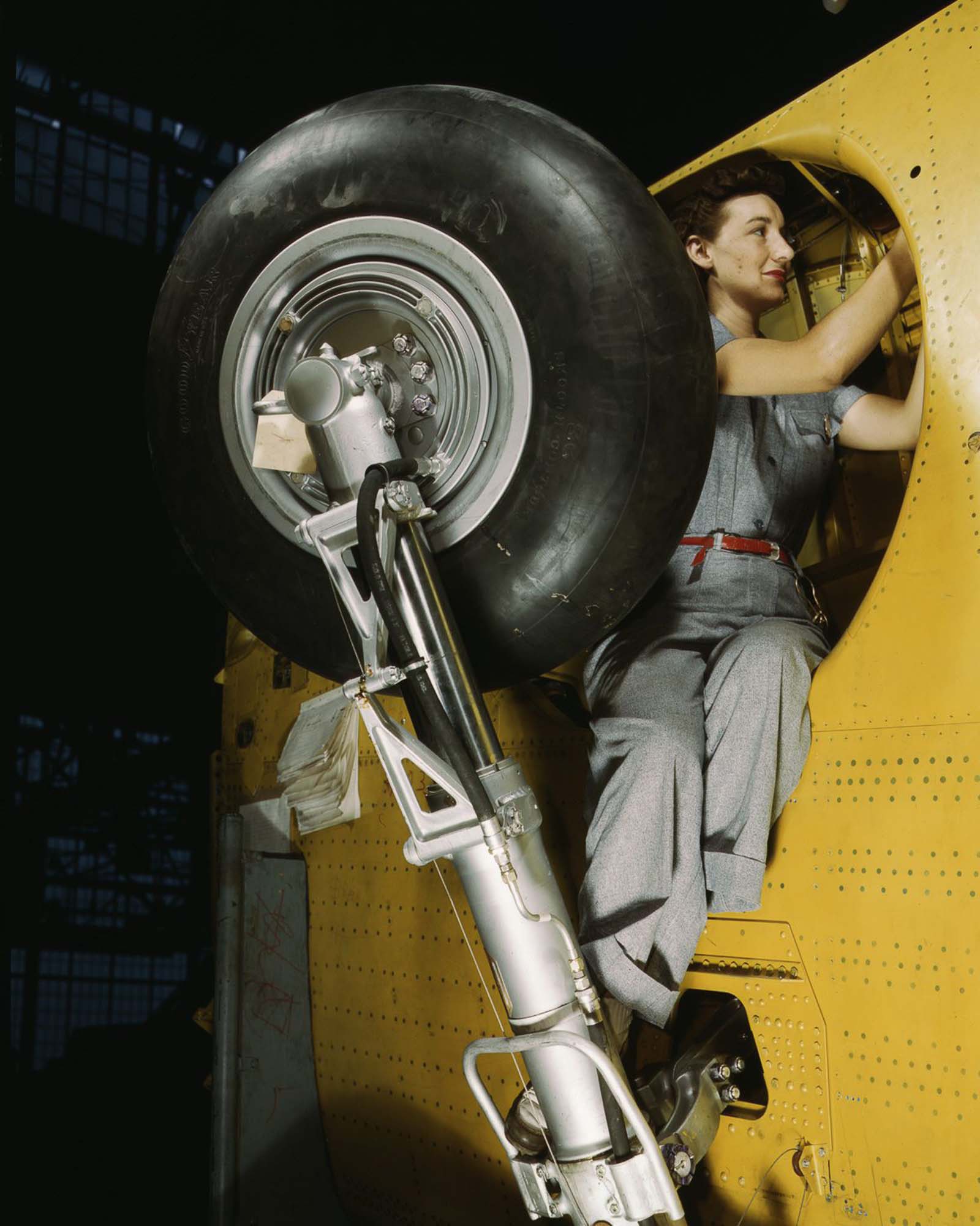 #28 A Vultee Aircraft worker makes adjustments to the wheel well of a “Vengeance” dive bomber before installation of the landing gear at the plant in Nashville, Tennessee, 1943.