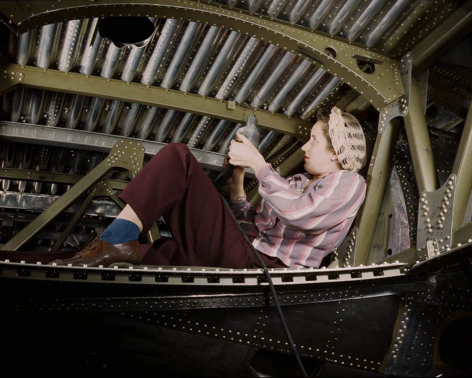 #9 A Douglas Aircraft Company worker rivets an A-20 bomber at the plant in Long Beach, California, 1942.