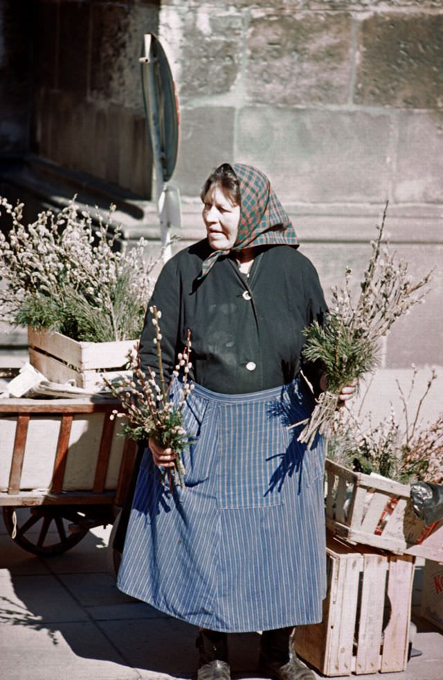 #33 Ulm. Woman selling her flowers at the town’s outdoor marketplace, Germany, 1972