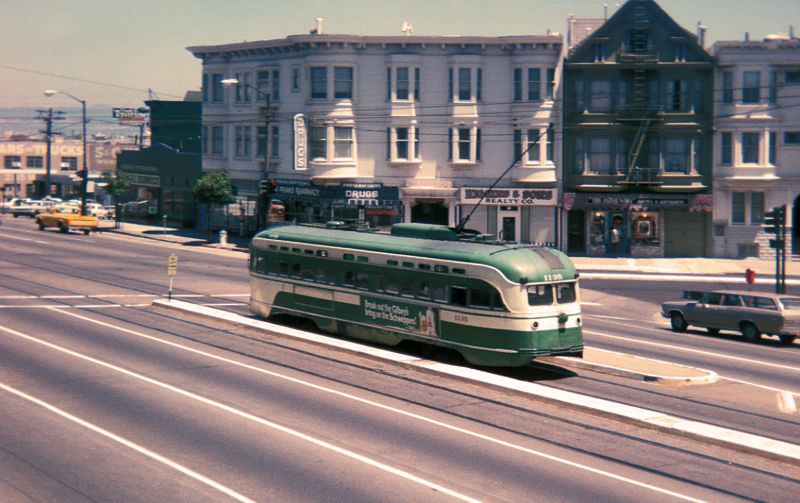#56 PCC heading downtown on Market Street between Noe Street/16th Street and Sanchez Street/15th Street on a foggy early evening, 1970