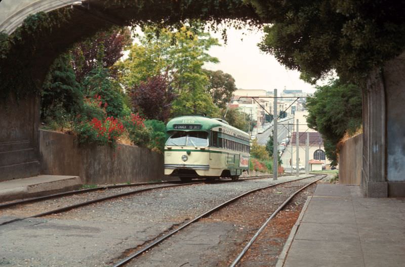 #12 PCC on the J-Line about to pass under the pedestrain walkway in Dolores Park at 19th, 1971