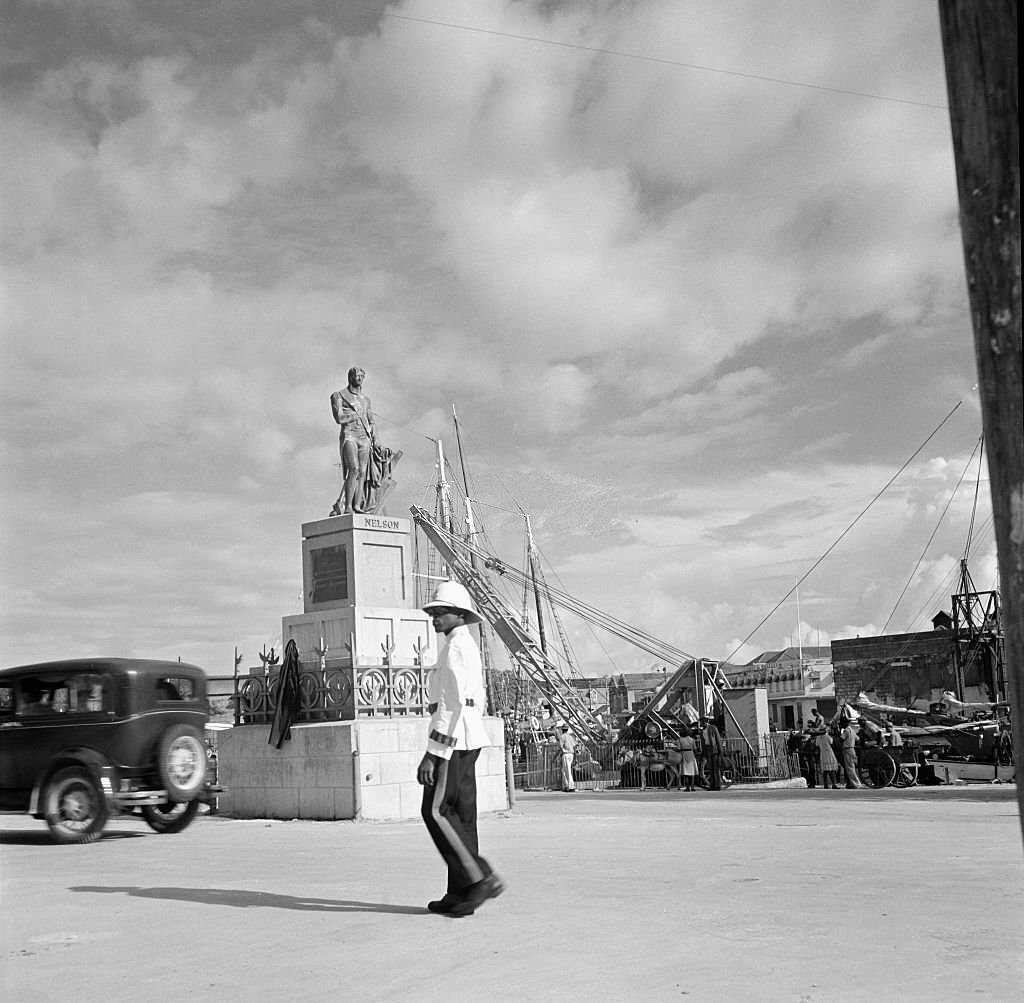 #67 A policemen walks past Lord Nelson Statue in Bridgetown, 1946