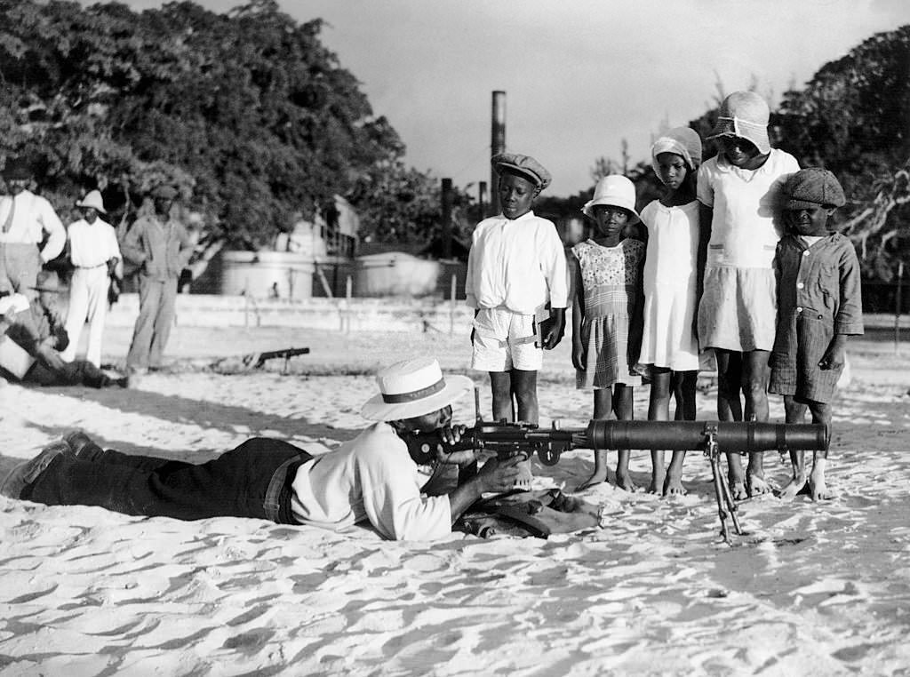 #73 Children watching a Policeman on a Beach of Bridgetown, 1930