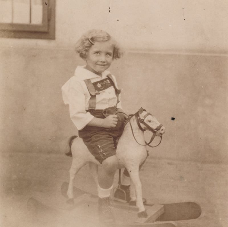 #12 Little girl riding on a rocking horse, 1926