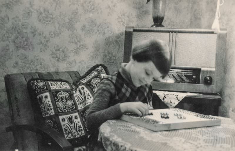 #16 Little girl playing a board game, 1930s