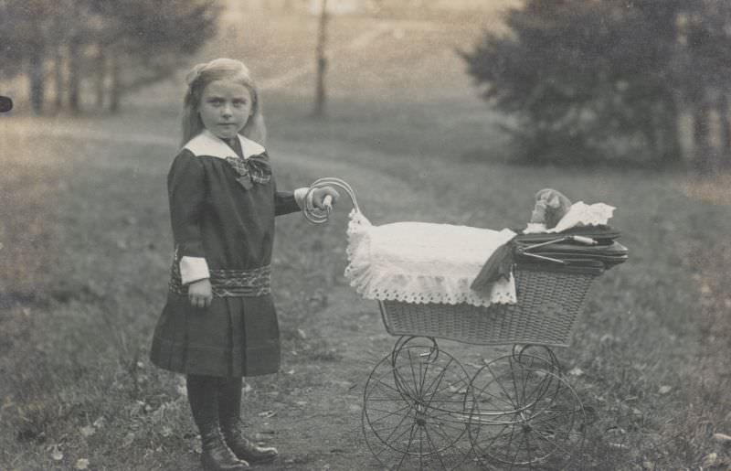 #2 Little girl pushing a stroller and doll, 1900s
