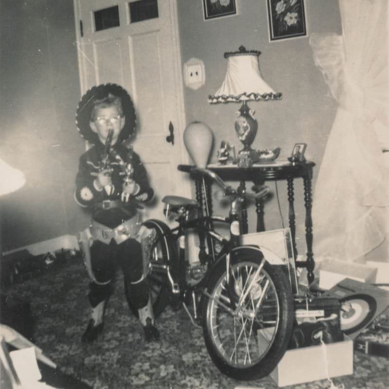 #33 Little boy dressed as a cowboy posing with his new bike
