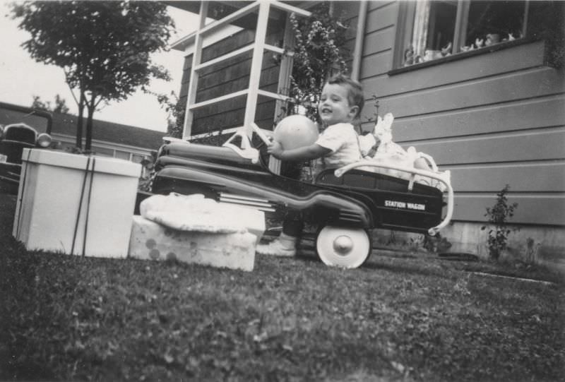 #38 Little boy riding in a toy car
