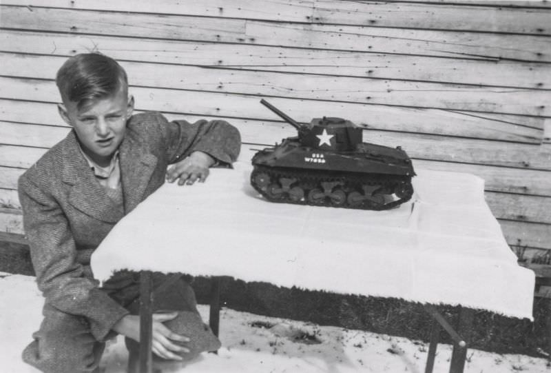 #39 Little boy showing off a toy tank