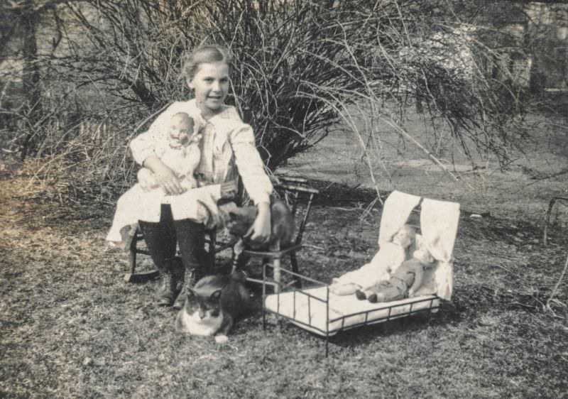 #4 Little girl sits with her dolls and cats, 1910s