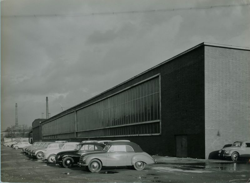 #13 Side of factory building with sedans and cabriolets, 1951