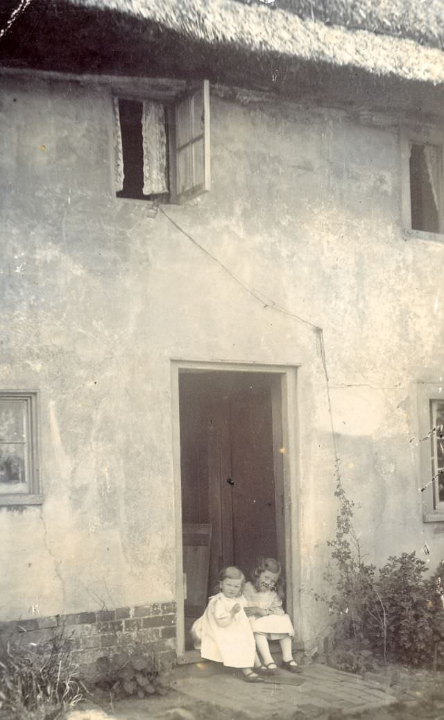 #32 On the door step of a thatched cottage