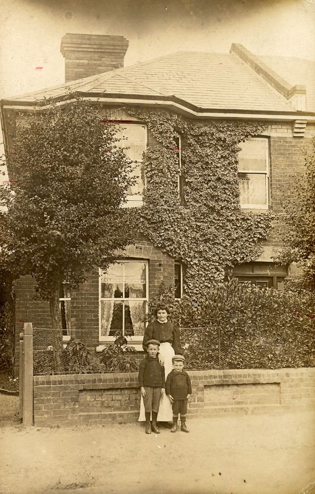 #8 A small Edwardian family outside their ivy-clad house