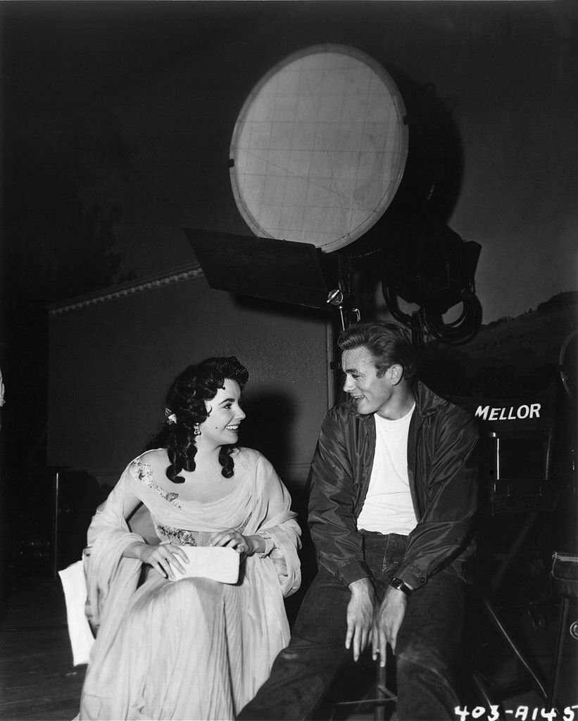 #16 ames Dean and Elizabeth Taylor chat on the set of the Warner Bros film ‘Giant’ in 1955 in Los Angeles, California.