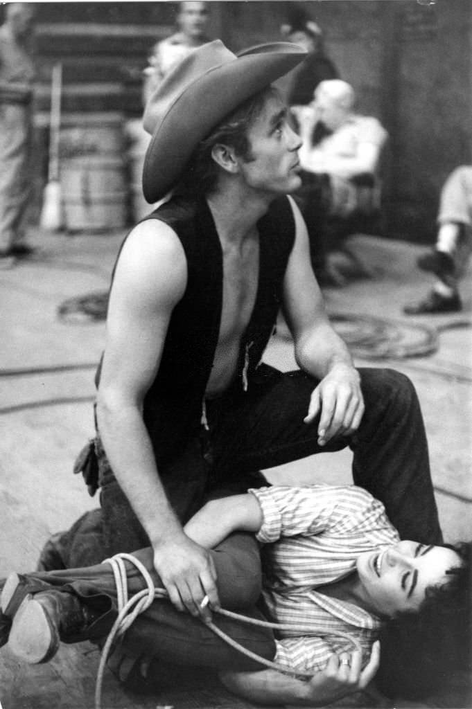#20 Elizabeth Taylor tangled in a lasso on the floor, during the filming of ‘Giant’.