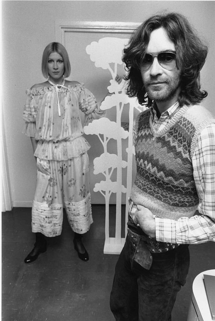 #15 British fashion designer Ossie Clark at a London studio with a model in one of his new outfits.