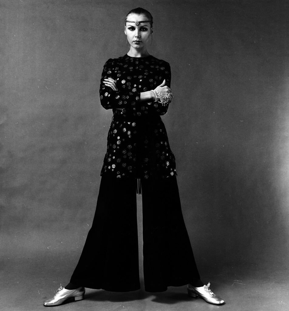 #5 A model wearing a tunic top and crepe wide-legged trousers.