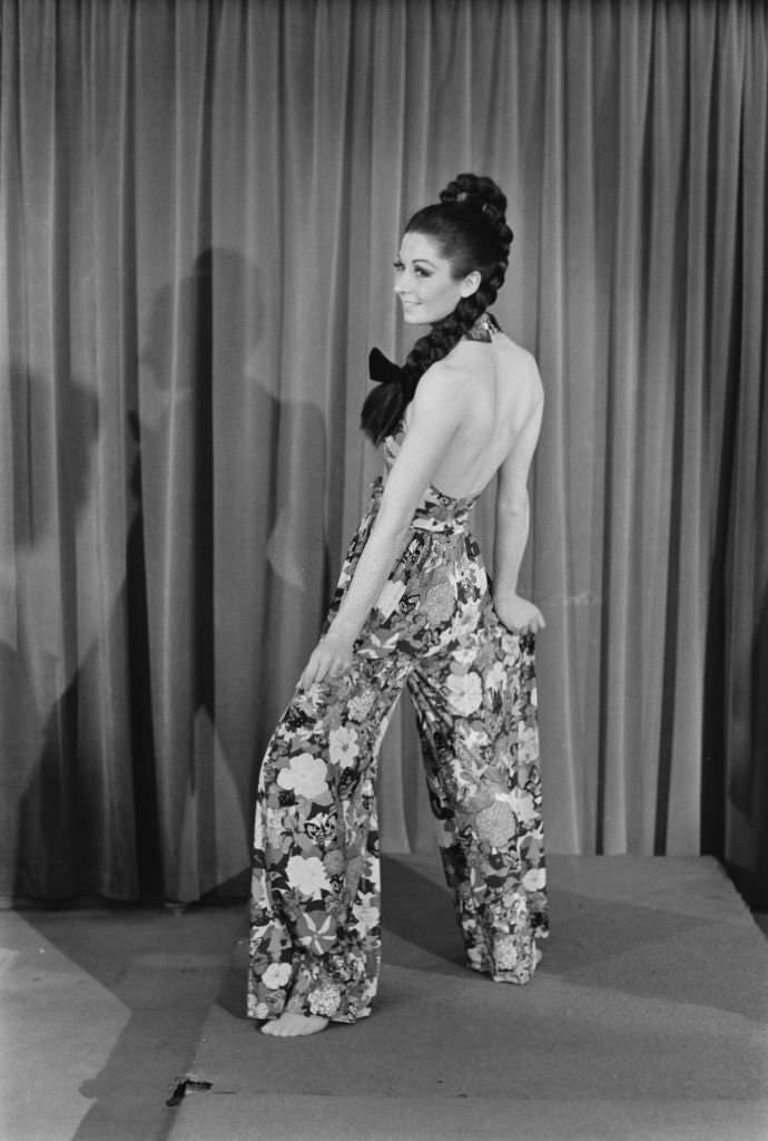 #8 A model wearing halterneck culottes in a floral butterfly pattern.