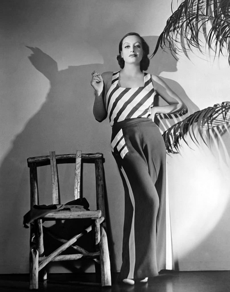 Joan Crawford poses in a pair of indoor red and white pajamas that she wore in her latest movie ‘Grand Hotel’ in 1932 in New York City.
