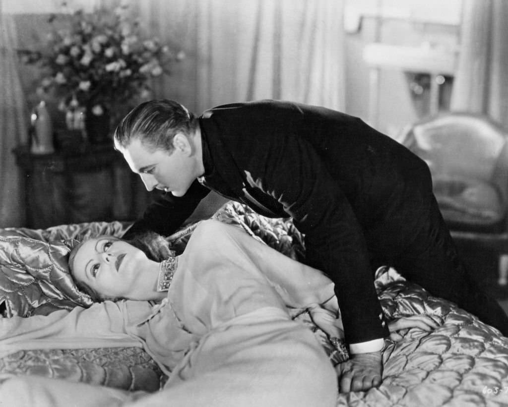 #51 Greta Garbo as John Barrymore is about to join her in a scene from the film ‘Grand Hotel’, 1932.