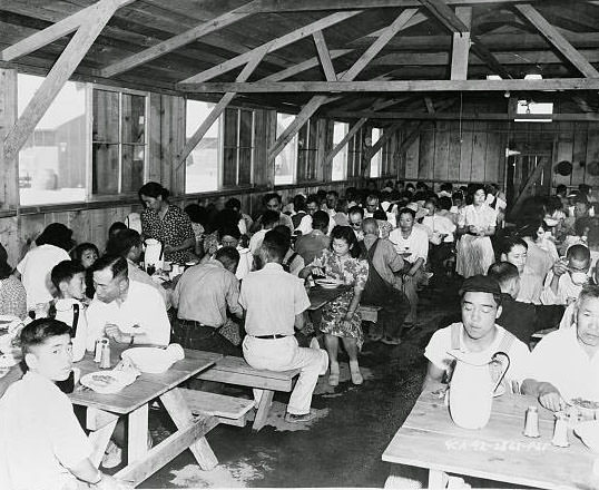 #11 Evacuees enjoying a hearty meal in Center dining hall / U.S. Army Signal Corps.