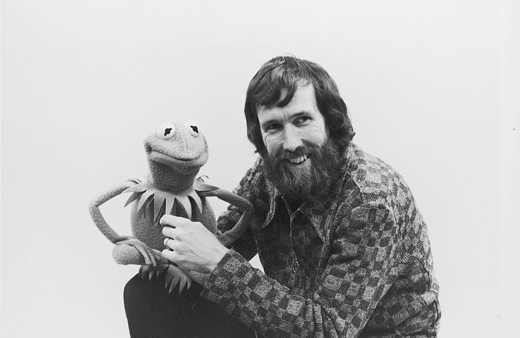 #14 Portrait of American film & televison director and puppeteer Jim Henson (1936 – 1990) as he holds muppet Kermit the Frog, late 1970s or early 1980s.