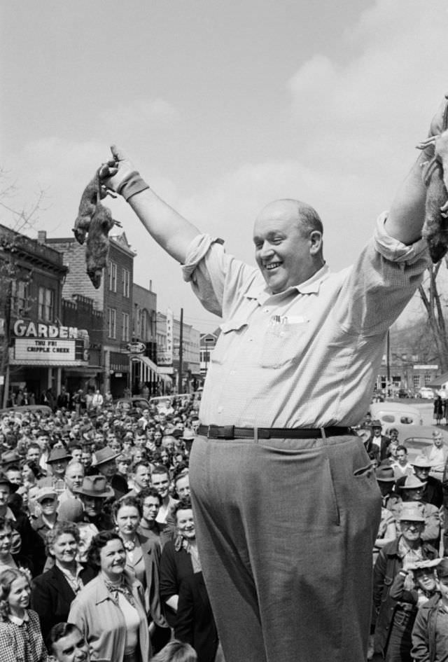 #12 Rat catcher shows his bounty in the town square, Louisa Kentucky, 1953.
