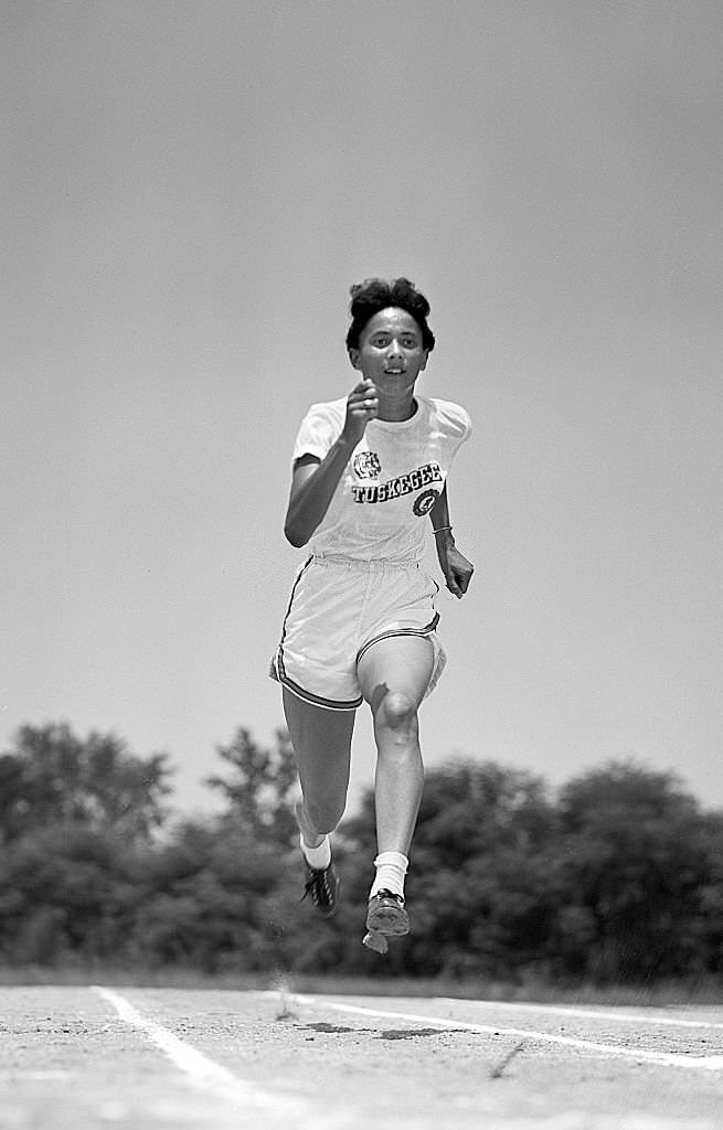#23 Tuskegee Nell Jackson in action during photo shoot on campus, 1952