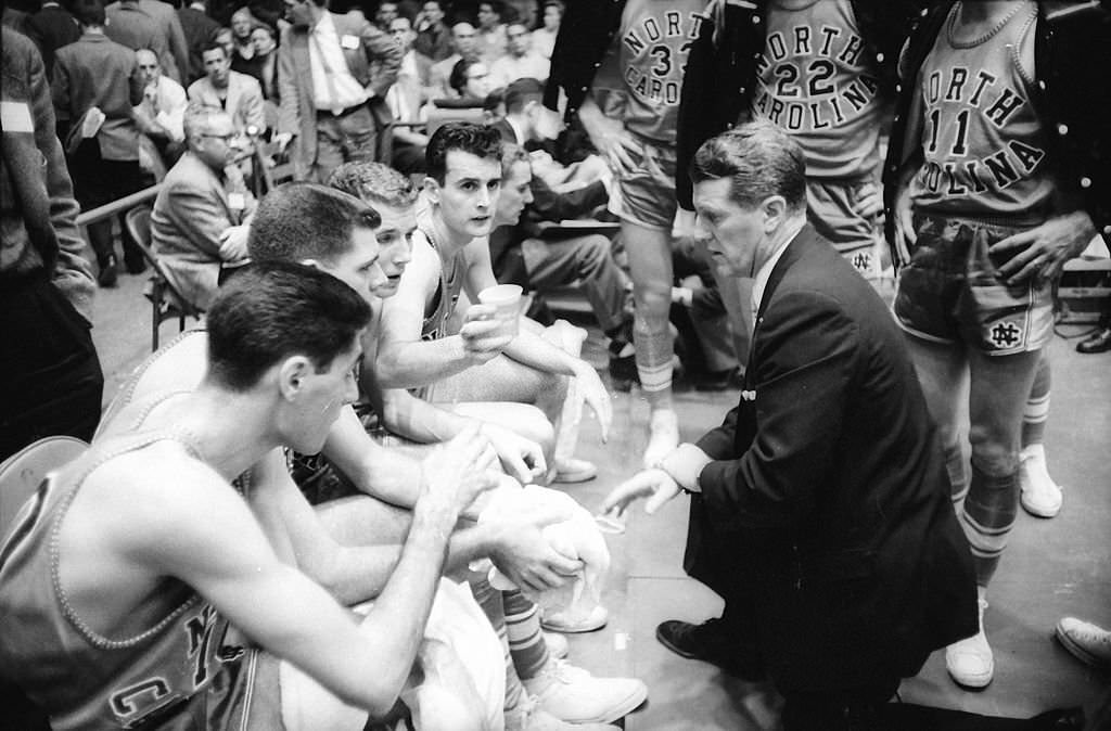 #45 UNC head coach Frank McGuire and team in the locker room.