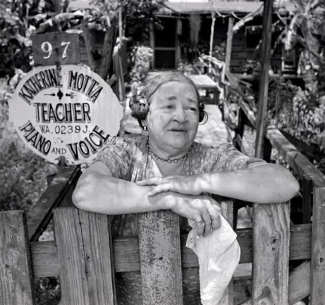 #9 Music teacher Katherine Motta in front of her home, 1953.