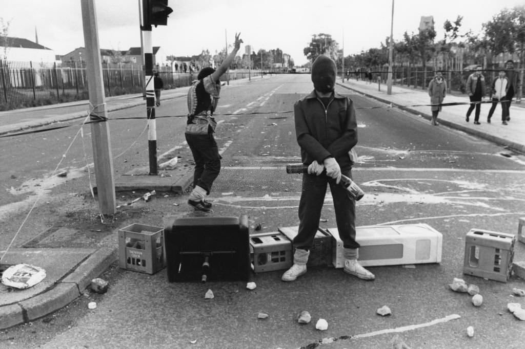 #6 A youth wearing a balaclava and holding bottles, during rioting in the Toxteth area of Liverpool, 5th July 1981.
