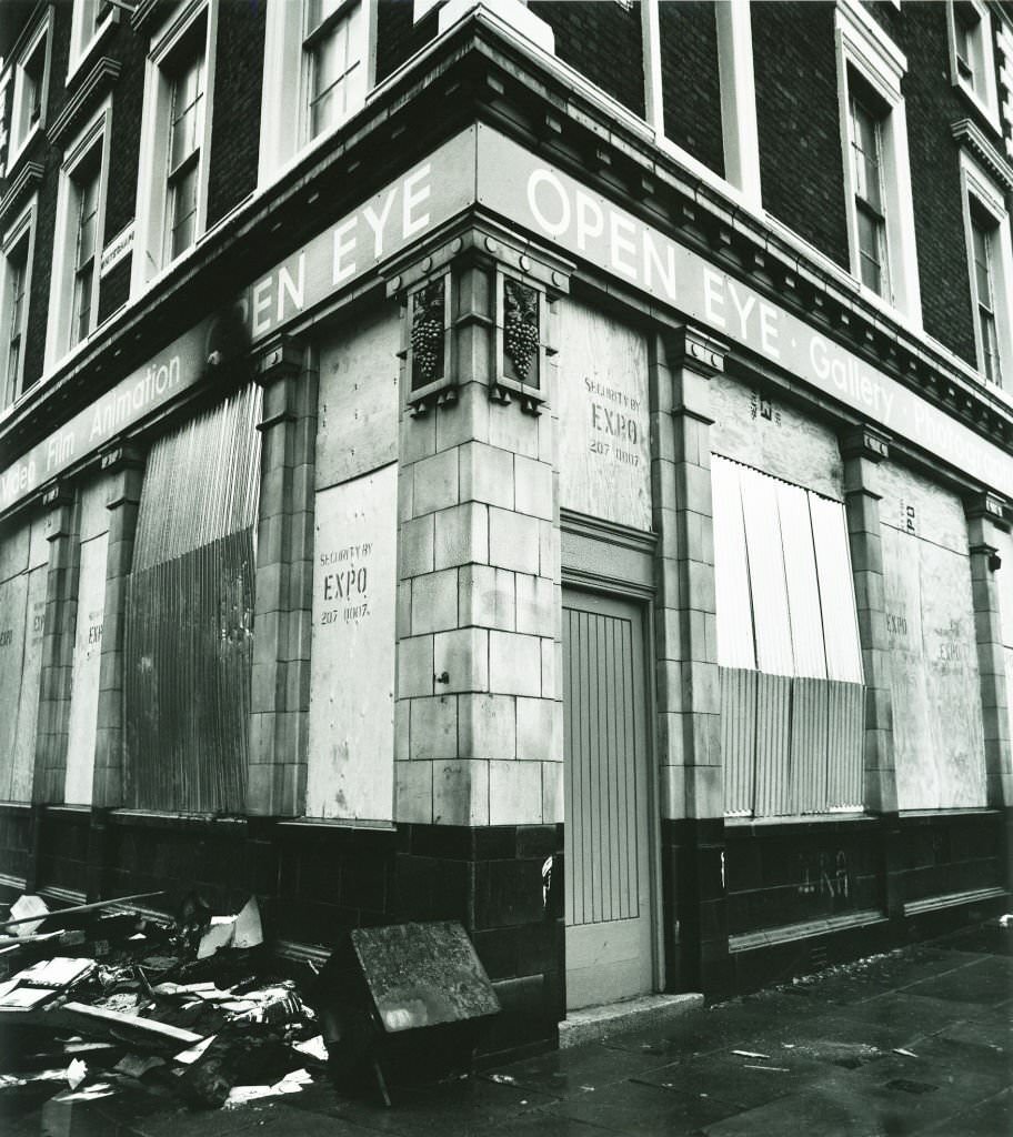 #84 The original Open Eye gallery in Liverpool, boarded up after being fire-bombed whilst showing the work of local photographer John Stoddart, 1983.