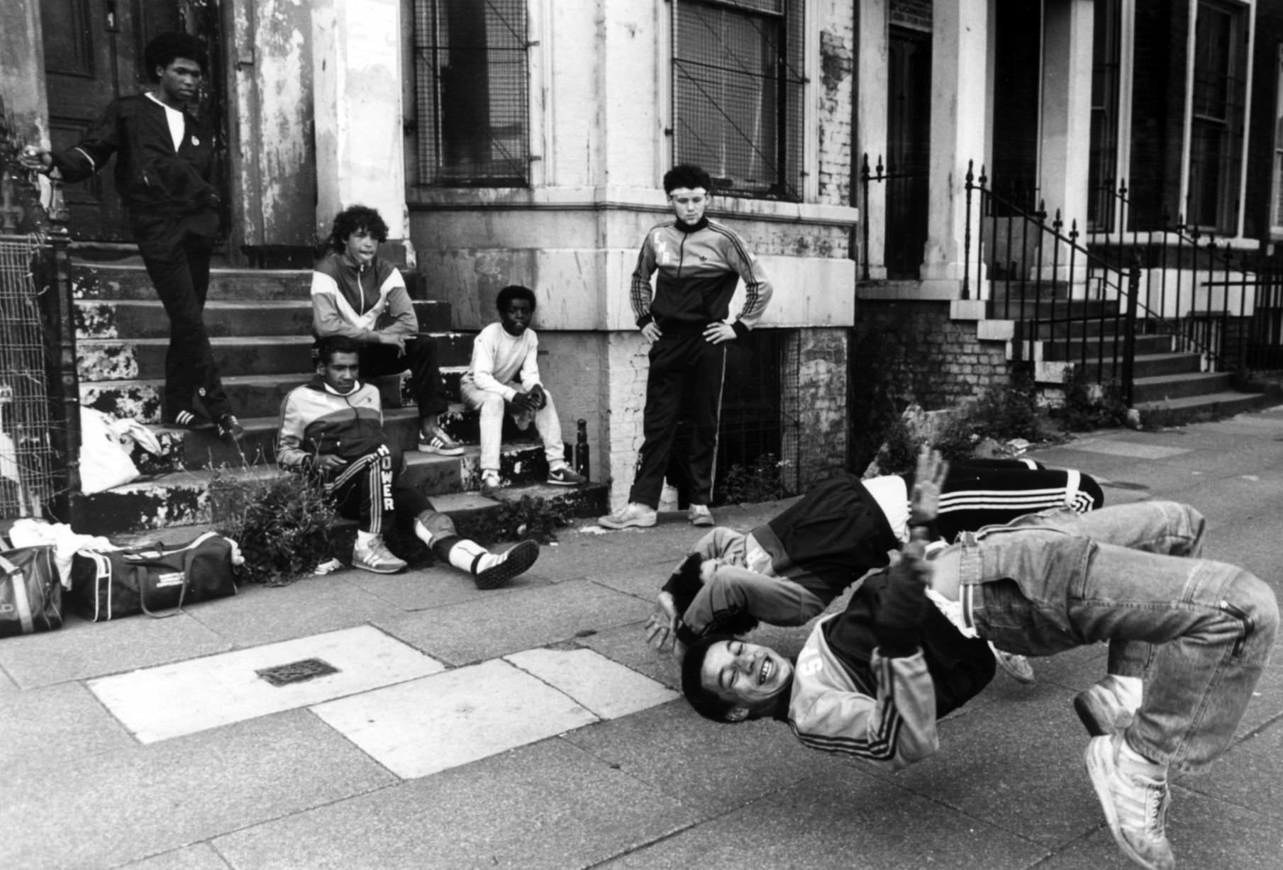 #43 A group of breakdancers, the Eastwood Rockers, going through their break dancing paces on the streets of Liverpool.